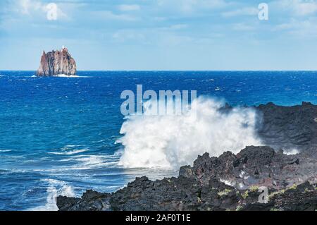 Waves by Stromboli island. Strombolicchio island and Strombolicchio lighthouse. Lipari islands. Italy. Stock Photo