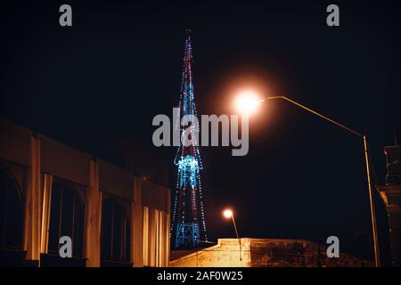 Transmitter tower decorated with lights as christmas tree with colonial building and street lights, Merida, Yucatan, Mexico Stock Photo