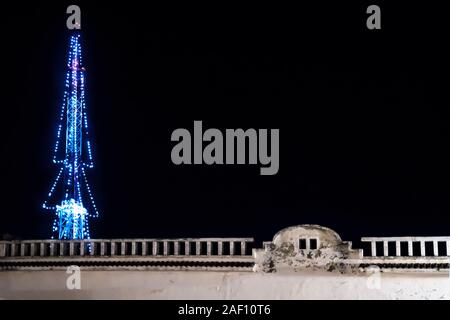 Transmitter tower decorated with lights as christmas tree with colonial building, Merida, Yucatan, Mexico Stock Photo