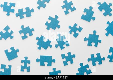 top view of scattered blue jigsaw puzzle on white background Stock Photo