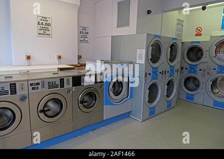 Interior of Eastover Launderette Laundry Room,with commercial washing machines and stacked dryers in Bridgwater, Somerset, England, UK. Stock Photo