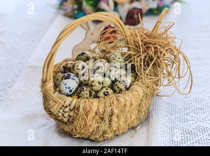 Rotten eggs in a basket of vegetable vibes on a tablecloth decorated with traditional Romanian motifs. Conceptual picture for diet food Easter Holiday Stock Photo