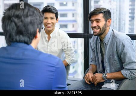 Psychotherapist inquiring about symptoms occurring within mind from patients with mental health problems in hospital. Group psychotherapy for support Stock Photo