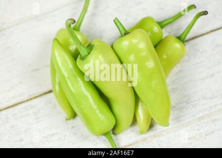 Fresh banana peppers or sweet pepper green garden on a white wooden background / Capsicum annuum Stock Photo