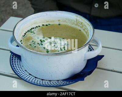 Plate of vegetable soup at Jausen Station Restaurant in Schonbrunn Palace, Vienna during lunch at summer Stock Photo