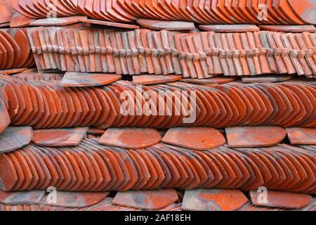 Closeup stack of traditional ceramic roof tiles used for covering rooftop of Thai temples Stock Photo