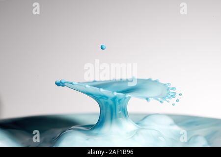 High resolution high megapixel image of a water drop splash with  blue, and baby blue, representing themes of change, impact, gender, boy Stock Photo