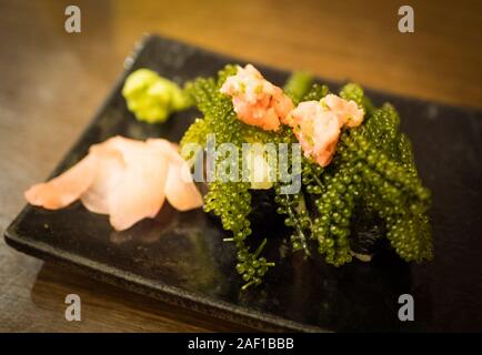 Delicious umi-budo (umi budo), also known as sea grapes or Caulerpa lentillifera, is a popular dish in Okinawa, Japan. Stock Photo