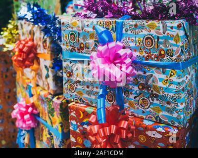 Colorful gift box background. Cute present boxes with colorful bows and ribbons in happy new year party. Stock Photo