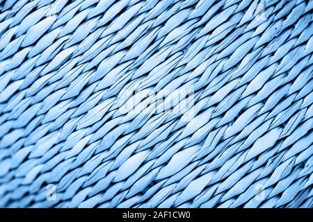 The texture of the straw basket in blue color. The concept of summer, garden furniture, vacations, beach accessories, etc. Stock Photo