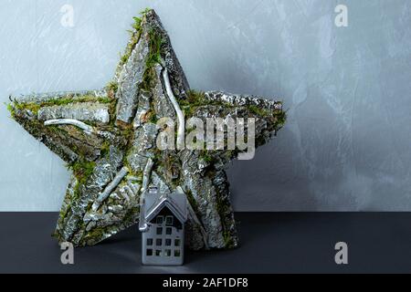 Decorative stars on the wall made from bark of wood and craft ceramic house Stock Photo