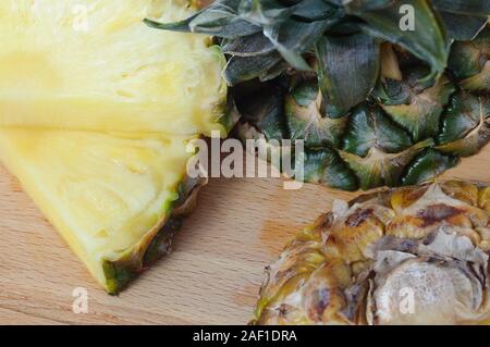 Flat lay of pineapple cut in slice. wooden table. Top view, overhead Stock Photo