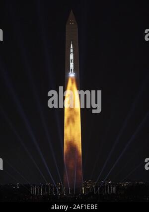 Washington, United States. 12th Dec, 2019. The Saturn V rocket that launched Apollo 11, part of 'Apollo 50: Go for the Moon,' a special 17-minute show, is projected onto the east face of the Washington Monument in Washington, DC on July 19, 2019. The Smithsonian and NASA are celebrating the 50th anniversary of the Apollo 11 mission that took man to the moon. Neil Armstrong, Buzz Aldrin, and Michael Collins took off from Earth on July 16, 1969, and Armstrong and Aldrin landed on the moon on July 20, 1969. Photo by Pat Benic/UPI Credit: UPI/Alamy Live News Stock Photo