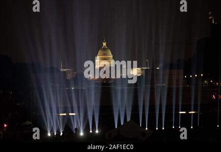 Washington, United States. 12th Dec, 2019. The U.S. Capitol is pictured in the background while 'Apollo 50: Go for the Moon,' a special 17-minute show, is projected onto the east face of the Washington Monument in Washington, DC on July 16, 2019. The Smithsonian and NASA are celebrating the 50th anniversary of the Apollo 11 mission that took man to the moon. Neil Armstrong, Buzz Aldrin, and Michael Collins took off from Earth on July 16, 1969, and Armstrong and Aldrin landed on the moon on July 20, 1969. Photo by Pat Benic/UPI Credit: UPI/Alamy Live News Stock Photo