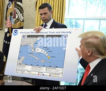 President Donald Trump displays an apparently altered map of the projected path of Hurricane Dorian during a briefing by federal agencies, as DHS Secretary Kevin McAleenan listens on at the White House in Washington, DC on Wednesday, September 4, 2019. The map appears to have been altered with a Sharpie to include Alabama, though the National Weather Service never included Alabama in its projected path maps of Dorian, which battered the Bahamas but veered north of Florida. Trump had mistakenly raised the alarm in Alabama over the weekend with a Tweet. Photo by Mike Theiler/UPI