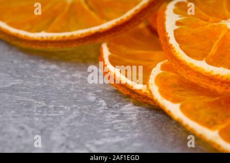 Closeup Of Dried Orange Slices On Stone Substrate Stock Photo