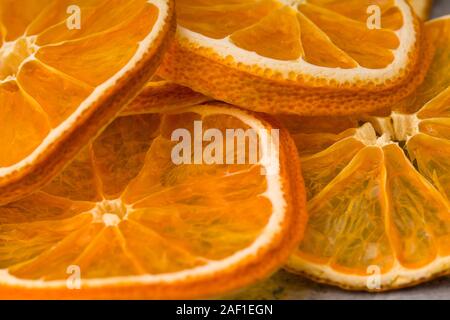 Dried orange slices chips background. Dehydrated crispy fruit slices Stock Photo