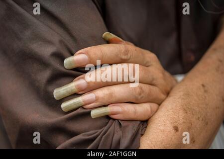 Sao Paulo, Brazil - December 16, 2015: Detail of a Brazilian homeless woman´s hand with huge nails Stock Photo