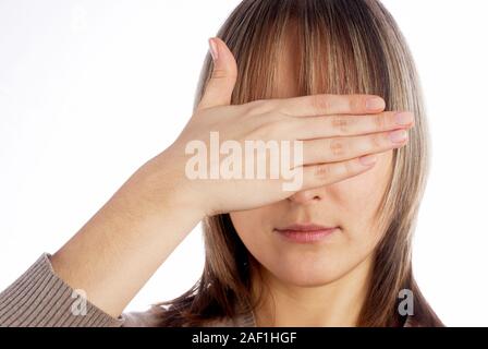 Woman covering eyes Stock Photo