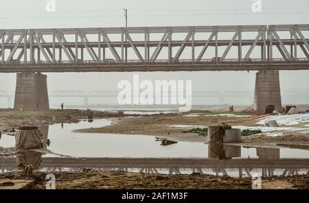 Agra, India - Nov 12, 2017. Steel bridge with Yamuna River at misty day in Agra, India. Air pollution in India is a serious health issue. Stock Photo