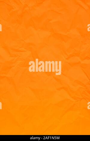 Orange crumpled wrinkled textured paper background. Empty space Stock Photo