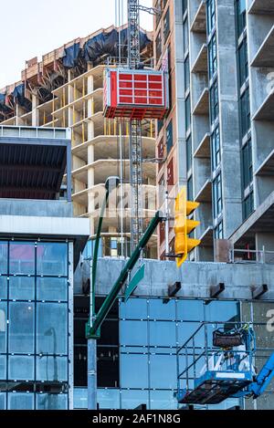 High-rise buildings under constraction with external elevator on the wall Stock Photo