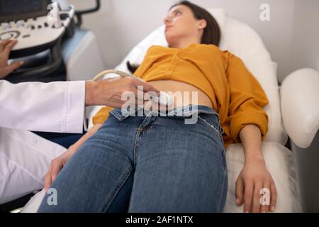 Female doctor making ultrasonic test to a pregnant woman Stock Photo