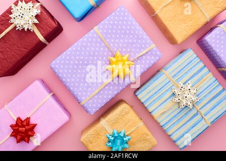 top view of wrapped gift boxes with bows on pink Stock Photo