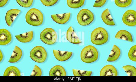 Kiwi fruit Slices macro. Ripe Kiwi fruit isolated on blue background. Stock Photo