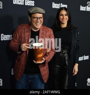 Hollywood, California, USA. 12th Dec, 2019. Actor Rob Schneider and his wife Patricia Azarcoya Schneider attend the premiere of the motion picture crime thriller 'Uncut Gems' at the ArcLight Cinema Dome in the Hollywood section of Los Angeles on Wednesday, December 11, 2019. Storyline: Howard Ratner (Adam Sandler), a charismatic New York City jeweler always on the lookout for the next big score. Credit: UPI/Alamy Live News Stock Photo