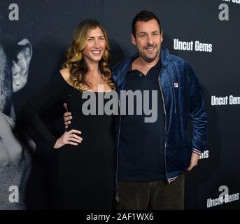 Hollywood, California, USA. 12th Dec, 2019. Cast member Adam Sandler and his wife Jackie Sandler attend the premiere of the motion picture crime thriller 'Uncut Gems' at the ArcLight Cinema Dome in the Hollywood section of Los Angeles on Wednesday, December 11, 2019. Storyline: Howard Ratner (Adam Sandler), a charismatic New York City jeweler always on the lookout for the next big score. Credit: UPI/Alamy Live News Stock Photo