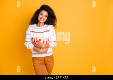 Photo portrait of nice glad positive satisfied lovely romantic cute girl ready for enjoying favorite comedy holding popcorn in hands isolated bright Stock Photo