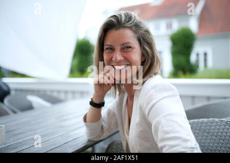 Smiling woman looking at camera Stock Photo