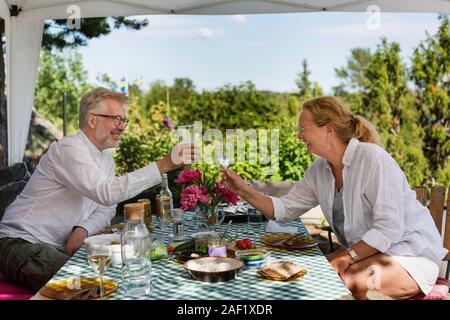 Mature couple having meal in garden Stock Photo