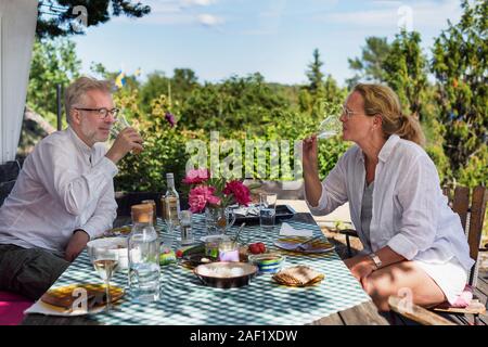 Mature couple having meal in garden Stock Photo