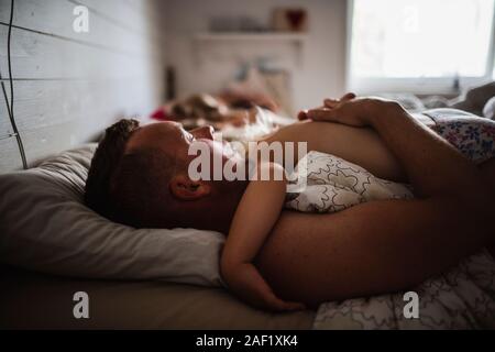 Father and child sleeping in bed Stock Photo
