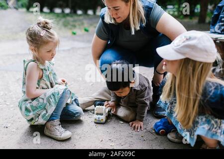 Teacher with children outside Stock Photo