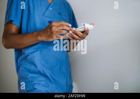 Man wearing scrubs, mid section Stock Photo