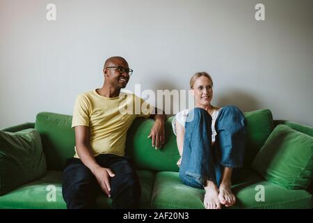 Couple sitting on sofa Stock Photo