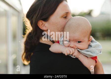 Mother carrying baby daughter Stock Photo