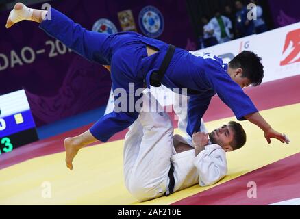 (191212) -- QINGDAO, Dec. 12, 2019 (Xinhua) -- Manuel Lombardo (bottom) of Italy competes with An Baul of South Korea during a men's 66kg second round match at the 2019 IJF World Judo Tour Qingdao Masters in Qingdao, east China's Shandong Province, Dec. 12, 2019 (Xinhua/Li Ziheng) Stock Photo