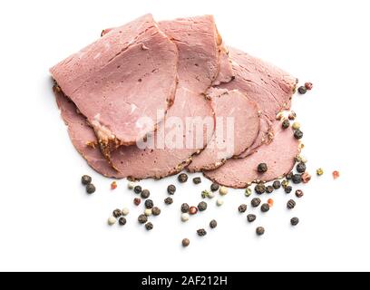 Sliced roast beef and whole pepper. Tasty fresh meat isolated on white backgrund. Stock Photo