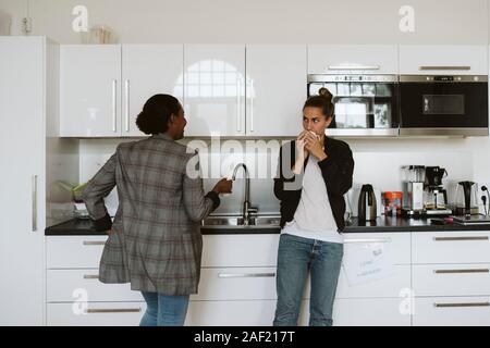 Women having coffee in kitchen Stock Photo
