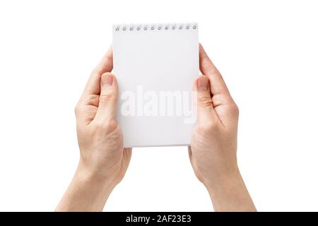 Male hands holding an open empty notebook. Isolated on white. Shot from above. Copy space. Stock Photo