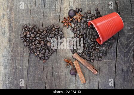 heart shaped in coffee  beans  and a spilled red cup with a spices-concept valentine Stock Photo