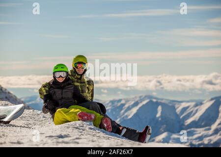 Lucky couple snowboarders in a mountain valley Stock Photo