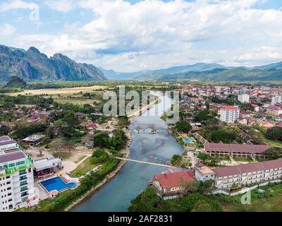 Bamboo bridge over Nam Song River at Vang Vieng village, Laos. Top view of the city. Urban landscape. Beautiful nature of Asia. Stock Photo