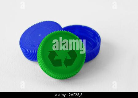 Plastic bottle caps with recycle symbol on white background - Concept of recyclable items and materials Stock Photo