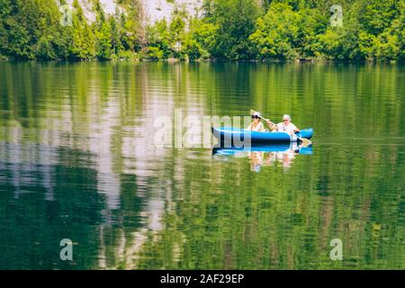 Scenery of senior people canoeing on Bohinj Lake Stock Photo