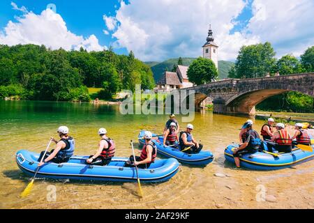 Scenery of men canoeing on Bohinj Lake in Slovenia Stock Photo